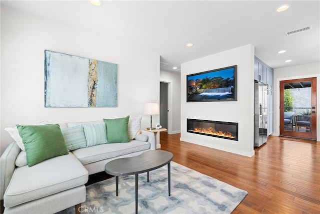 3409 W 175th St, Torrance, CA 90504 - living area featuring a glass covered fireplace, recessed lighting, wood finished floors, and baseboards