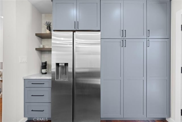 3409 W 175th St, Torrance, CA 90504 - kitchen with stainless steel refrigerator with ice dispenser, open shelves, light countertops, gray cabinets, and backsplash