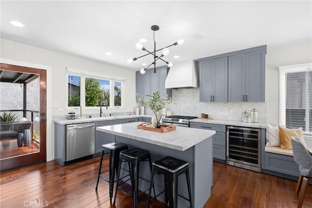 3409 W 175th St, Torrance, CA 90504 - kitchen featuring wine cooler, stainless steel appliances, custom range hood, gray cabinetry, and a breakfast bar area
