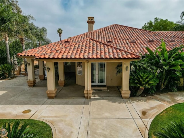 6116 Chadbourne Ave, Riverside, CA 92505 - back of property with french doors, a tiled roof, stucco siding, and a chimney