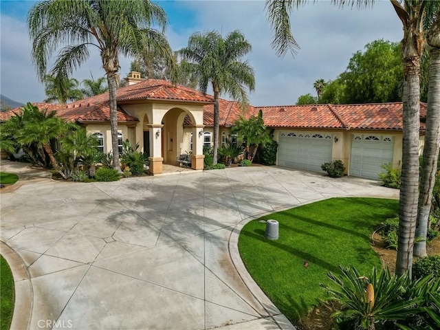 6116 Chadbourne Ave, Riverside, CA 92505 - mediterranean / spanish house featuring driveway, stucco siding, a garage, a tile roof, and a front yard