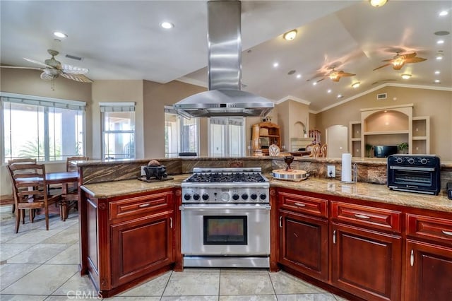 6116 Chadbourne Ave, Riverside, CA 92505 - kitchen featuring stainless steel stove, a ceiling fan, range hood, reddish brown cabinets, and ornamental molding