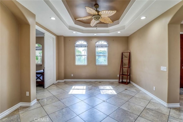 6116 Chadbourne Ave, Riverside, CA 92505 - spare room with a ceiling fan, arched walkways, recessed lighting, light tile patterned floors, and a raised ceiling