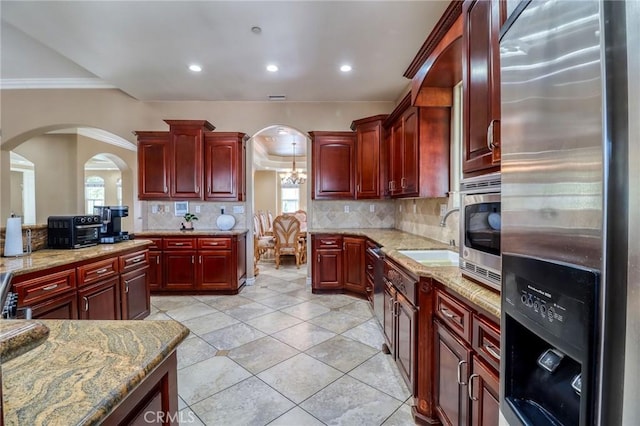 6116 Chadbourne Ave, Riverside, CA 92505 - kitchen with fridge with ice dispenser, dark brown cabinets, arched walkways, decorative backsplash, and crown molding