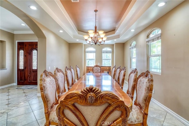 6116 Chadbourne Ave, Riverside, CA 92505 - dining space with arched walkways, a chandelier, recessed lighting, light tile patterned floors, and a tray ceiling