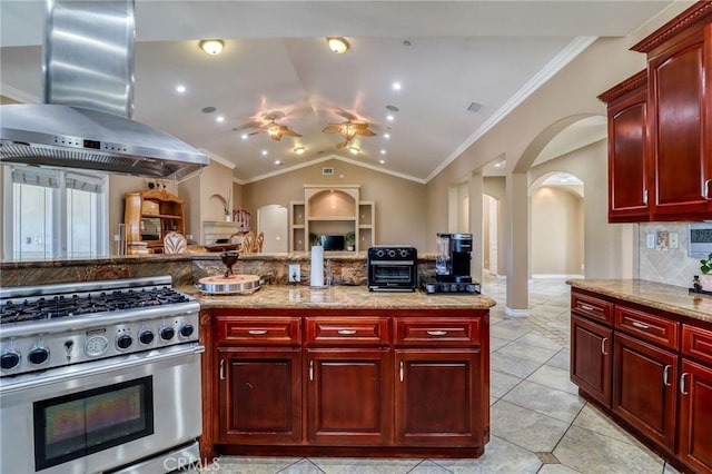 6116 Chadbourne Ave, Riverside, CA 92505 - kitchen featuring high end stove, dark brown cabinets, arched walkways, wall chimney exhaust hood, and tasteful backsplash