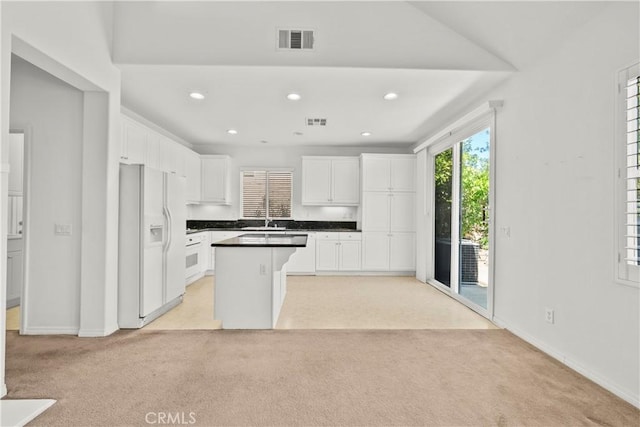 28538 Redwood Canyon Pl, Saugus, CA 91390 - kitchen featuring white fridge with ice dispenser, light colored carpet, a sink, white cabinetry, and recessed lighting