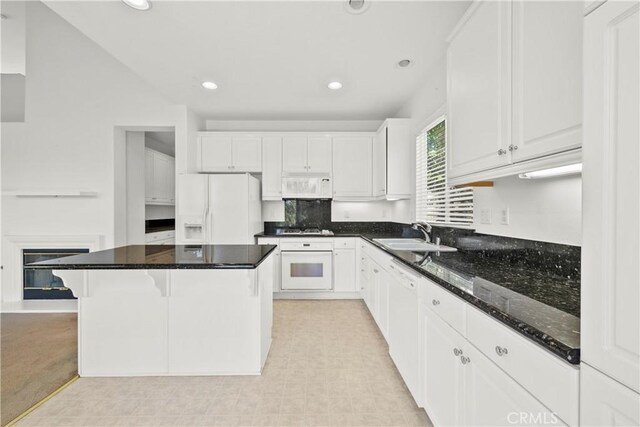 28538 Redwood Canyon Pl, Saugus, CA 91390 - kitchen with white appliances, a sink, a kitchen island, white cabinetry, and recessed lighting