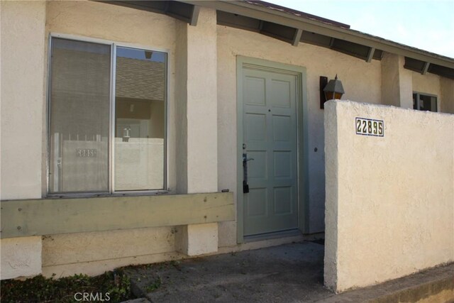 22895 Caminito Sol Unit 155, Laguna Hills, CA 92653 - view of exterior entry with stucco siding