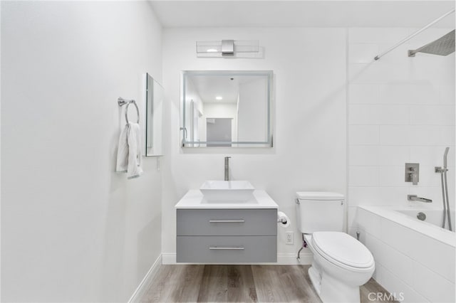 1310 E Ocean Blvd Unit 1103, Long Beach, CA 90802 - full bathroom featuring vanity, toilet, shower / bath combination, wood finished floors, and baseboards