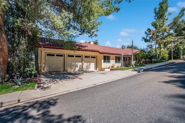 3300 Beaudry, Glendale, CA 91208 - view of front of property featuring a tiled roof, a garage, stucco siding, and driveway