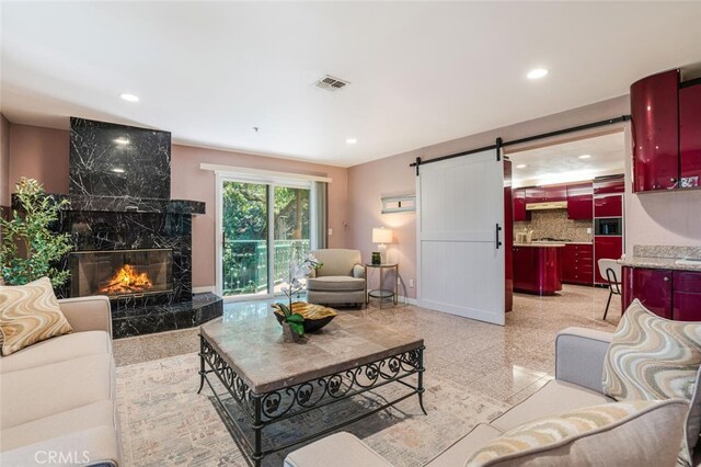 3300 Beaudry, Glendale, CA 91208 - living area with a barn door, a high end fireplace, granite floors, and recessed lighting