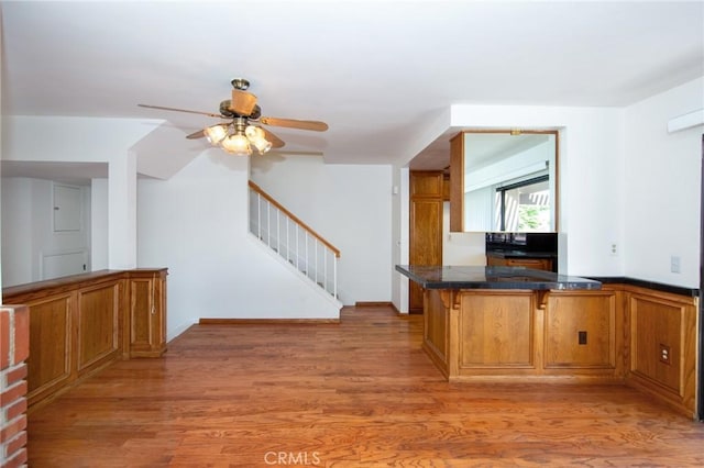 2440 Chandler Ave Unit 4, Simi Valley, CA 93065 - kitchen with a kitchen breakfast bar, brown cabinets, light wood-type flooring, ceiling fan, and tile countertops