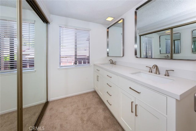 2440 Chandler Ave Unit 4, Simi Valley, CA 93065 - full bath with double vanity, baseboards, a textured ceiling, and carpet flooring