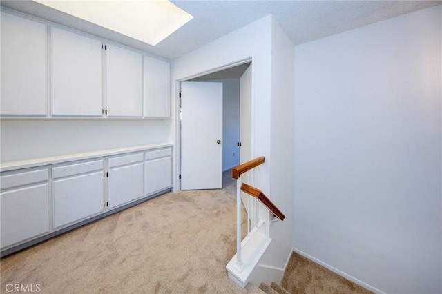 2440 Chandler Ave Unit 4, Simi Valley, CA 93065 - interior space featuring light carpet, an upstairs landing, baseboards, and a skylight
