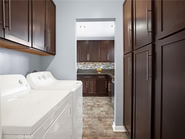 10404 Gaviota Ave, Granada Hills, CA 91344 - laundry room with washing machine and dryer, cabinet space, and stone finish floors