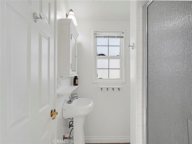 10404 Gaviota Ave, Granada Hills, CA 91344 - full bathroom featuring a stall shower and baseboards
