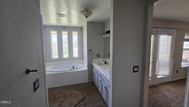 12780 Fir St, Oak Hills, CA 92344 - full bath with a garden tub, double vanity, and a textured ceiling