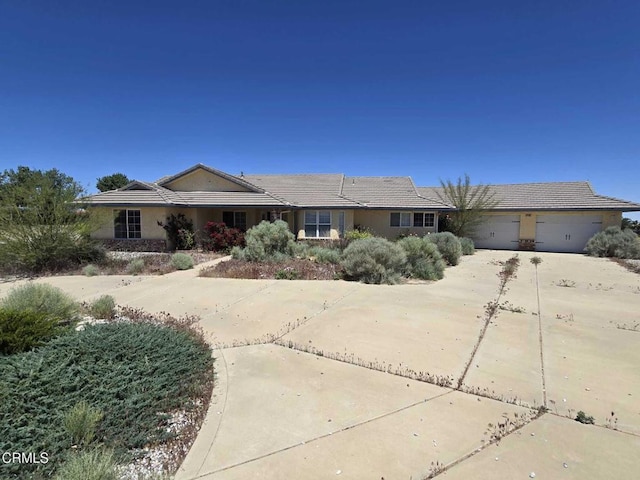 12780 Fir St, Oak Hills, CA 92344 - ranch-style home featuring a garage, driveway, a tiled roof, and stucco siding