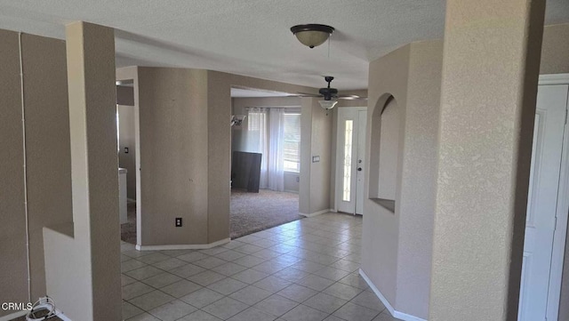 12780 Fir St, Oak Hills, CA 92344 - hallway with a textured wall, tile patterned floors, a textured ceiling, and baseboards
