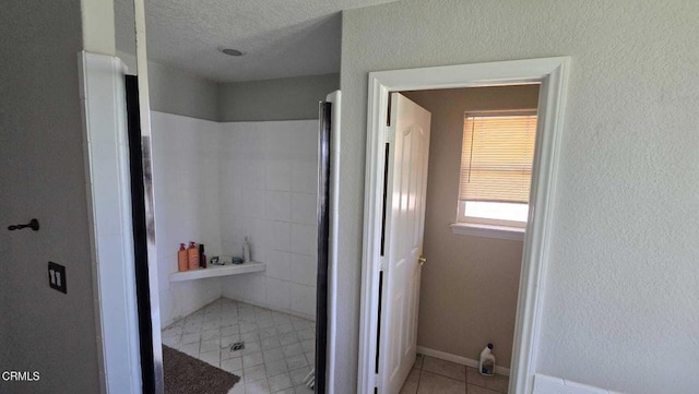 12780 Fir St, Oak Hills, CA 92344 - bathroom with a shower stall, tile patterned floors, and a textured ceiling