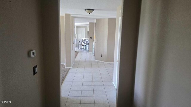12780 Fir St, Oak Hills, CA 92344 - hallway featuring light tile patterned floors and baseboards