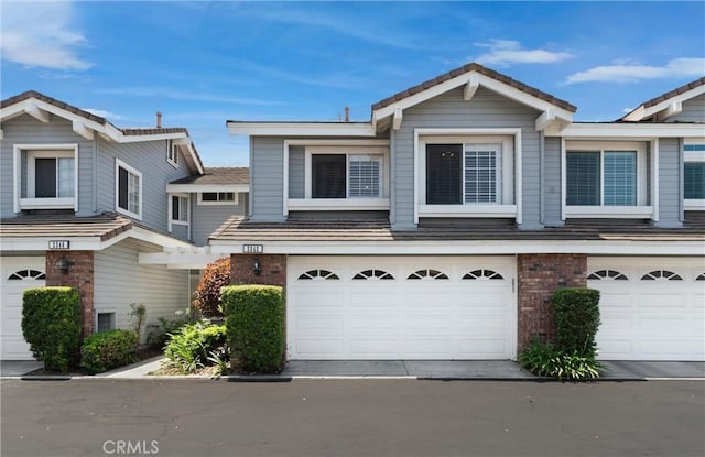 2342 Aspen St, Tustin, CA 92782 - view of front of home with a garage, brick siding, and a tile roof