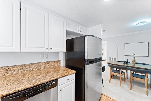 25541 Indian Hill Ln Unit P, Laguna Hills, CA 92653 - kitchen featuring stainless steel appliances, white cabinets, ornamental molding, and light stone counters