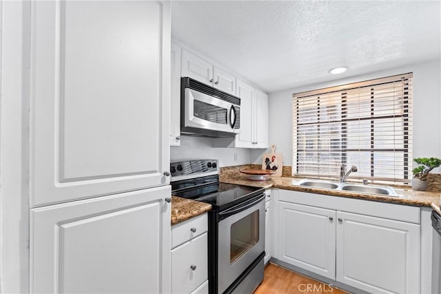 25541 Indian Hill Ln Unit P, Laguna Hills, CA 92653 - kitchen featuring stainless steel appliances, a textured ceiling, white cabinetry, light wood finished floors, and recessed lighting