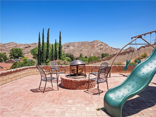 15242 Poppy Meadow St, Canyon Country, CA 91387 - view of patio / terrace with a playground, a mountain view, and a fire pit