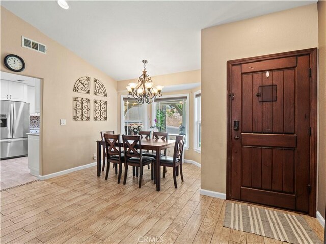 15242 Poppy Meadow St, Canyon Country, CA 91387 - dining space featuring a chandelier, light wood finished floors, baseboards, and lofted ceiling