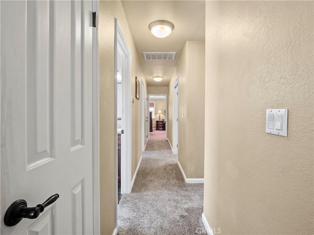 15242 Poppy Meadow St, Canyon Country, CA 91387 - corridor featuring carpet flooring, a textured wall, and baseboards