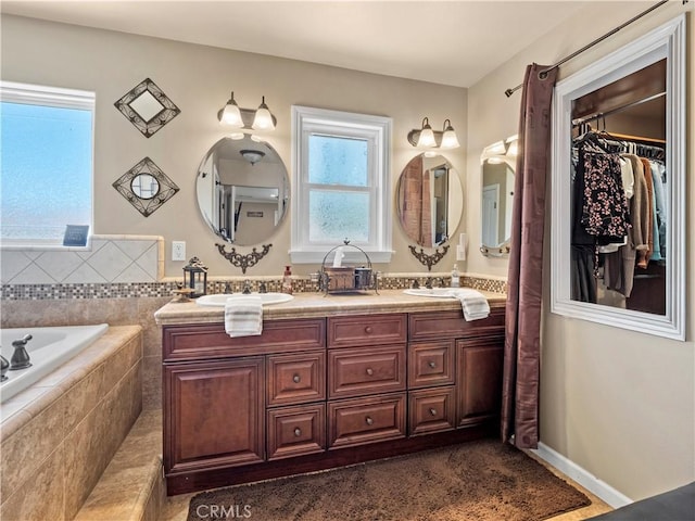 15242 Poppy Meadow St, Canyon Country, CA 91387 - bathroom featuring double vanity, a bath, and a spacious closet