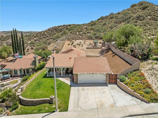15242 Poppy Meadow St, Canyon Country, CA 91387 - view of front of home with a tile roof, a mountain view, driveway, a garage, and a gate