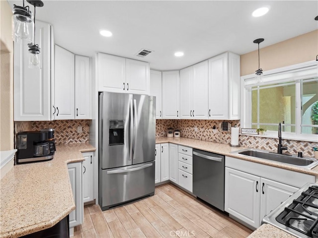 15242 Poppy Meadow St, Canyon Country, CA 91387 - kitchen with stainless steel appliances, a sink, white cabinetry, decorative backsplash, and recessed lighting