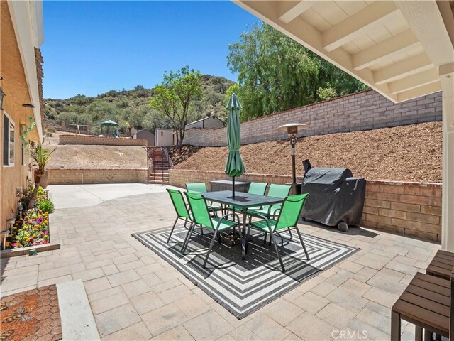 15242 Poppy Meadow St, Canyon Country, CA 91387 - fenced backyard featuring outdoor dining area, a patio, and grilling area