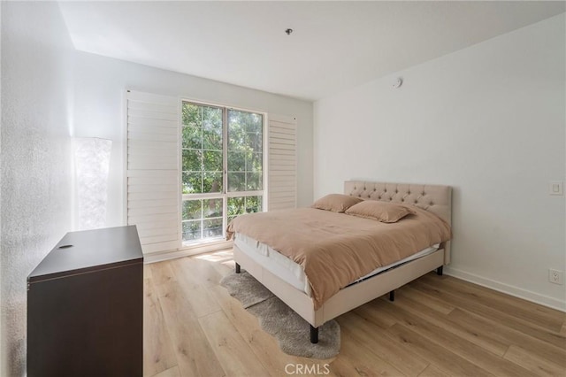 585 N Rossmore Ave Unit 209, Los Angeles, CA 90004 - bedroom with light wood finished floors, multiple windows, and baseboards