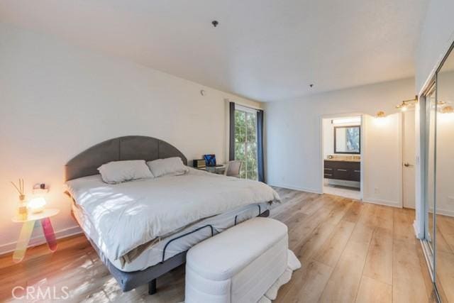 585 N Rossmore Ave Unit 209, Los Angeles, CA 90004 - bedroom featuring light wood-style floors, ensuite bathroom, and baseboards