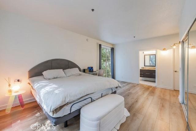 585 N Rossmore Ave Unit 209, Los Angeles, CA 90004 - bedroom with light wood-style floors, ensuite bath, and baseboards