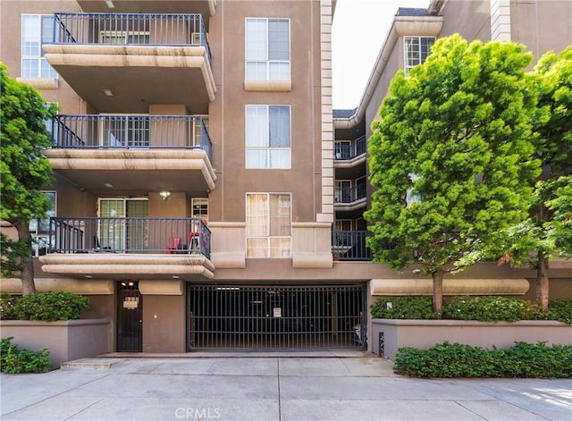 585 N Rossmore Ave Unit 209, Los Angeles, CA 90004 - view of apartment building / complex with an attached garage and concrete driveway
