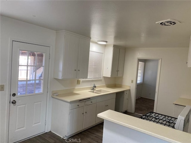 1017 W Prune Ave, Lompoc, CA 93436 - kitchen with a sink, dark wood-style flooring, light countertops, white cabinetry, and a peninsula
