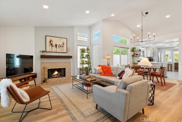 36364 Provence Dr, Murrieta, CA 92562 - living area with light wood-style floors, a tile fireplace, a chandelier, recessed lighting, and high vaulted ceiling