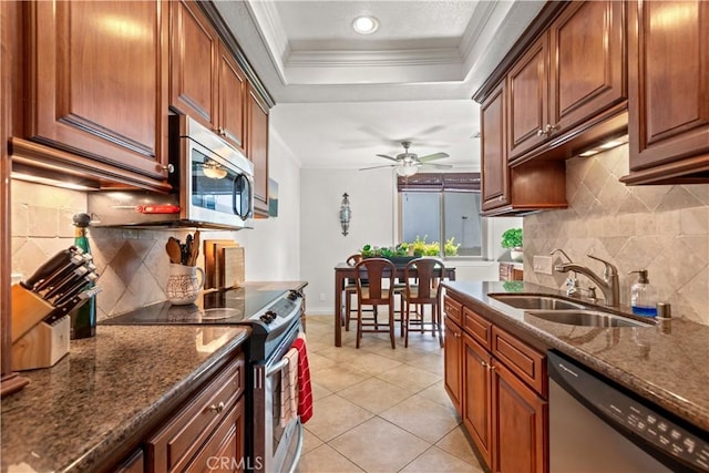 12531 Cluster Pines Rd, Garden Grove, CA 92845 - kitchen with stainless steel appliances, a sink, crown molding, a raised ceiling, and decorative backsplash