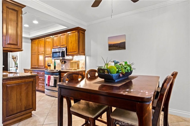12531 Cluster Pines Rd, Garden Grove, CA 92845 - kitchen with appliances with stainless steel finishes, a ceiling fan, light tile patterned floors, ornamental molding, and brown cabinets