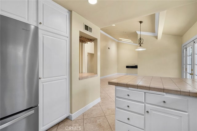1725 Aspen Village Way, West Covina, CA 91791 - kitchen featuring freestanding refrigerator, light tile patterned flooring, tile countertops, and white cabinetry