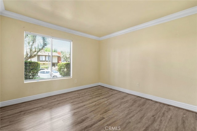 1725 Aspen Village Way, West Covina, CA 91791 - unfurnished room with wood finished floors, crown molding, and baseboards