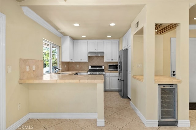1725 Aspen Village Way, West Covina, CA 91791 - kitchen featuring wine cooler, appliances with stainless steel finishes, under cabinet range hood, a peninsula, and a sink