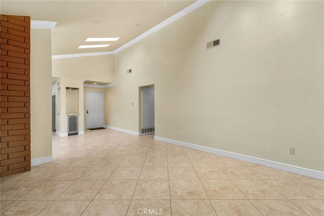 1725 Aspen Village Way, West Covina, CA 91791 - spare room with crown molding, light tile patterned flooring, high vaulted ceiling, and baseboards