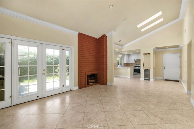 1725 Aspen Village Way, West Covina, CA 91791 - unfurnished living room featuring crown molding, a skylight, light tile patterned flooring, french doors, and a fireplace