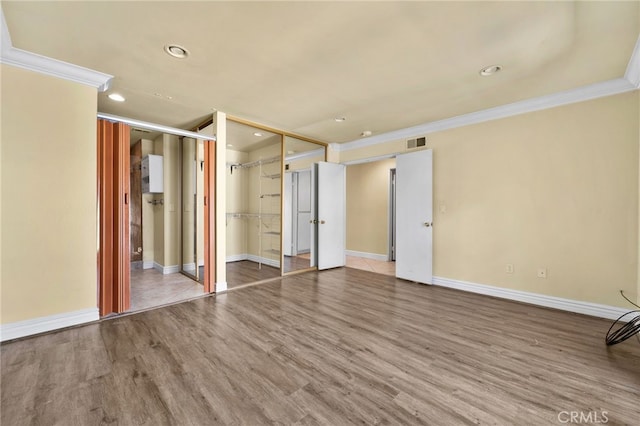 1725 Aspen Village Way, West Covina, CA 91791 - unfurnished bedroom featuring crown molding, baseboards, wood finished floors, recessed lighting, and a closet